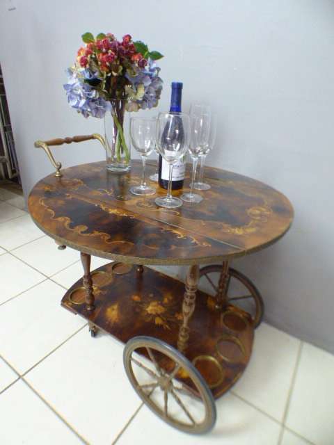 An exquisite Italian Sorrento style wood antique drinks trolley on original castors and wheels.