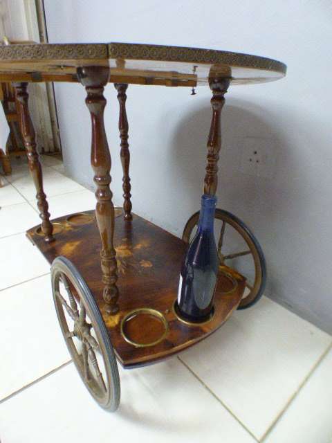 An exquisite Italian Sorrento style wood antique drinks trolley on original castors and wheels.