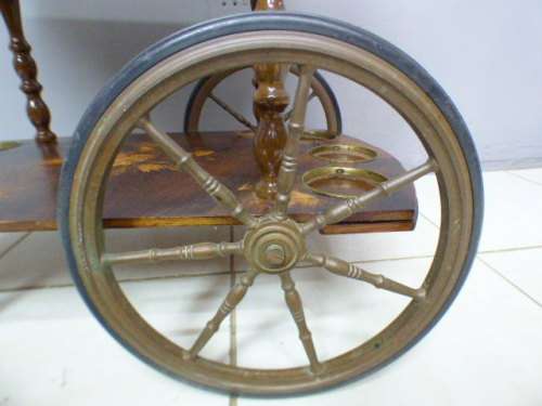 An exquisite Italian Sorrento style wood antique drinks trolley on original castors and wheels.