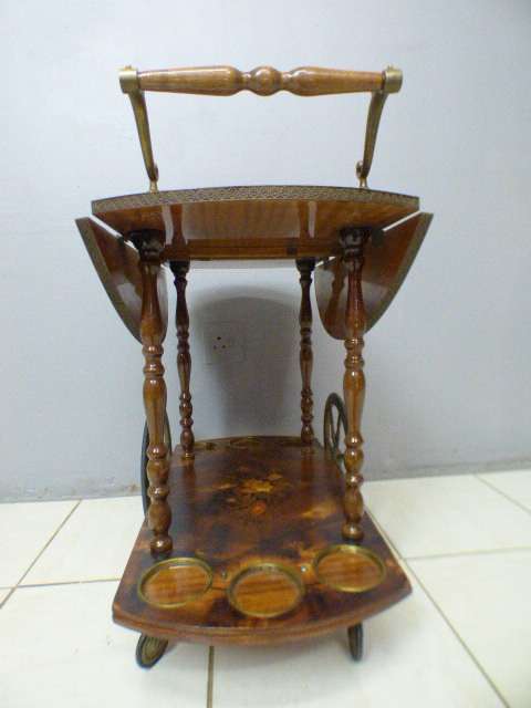 An exquisite Italian Sorrento style wood antique drinks trolley on original castors and wheels.