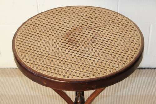 A stunning wicker-top occasional table with bentwood legs, something different in your home