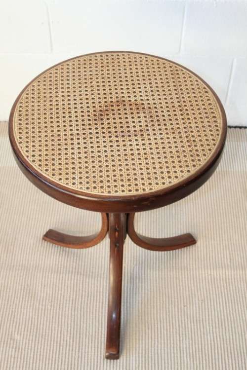 A stunning wicker-top occasional table with bentwood legs, something different in your home
