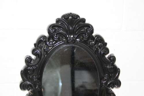 An amazing black ornately moulded oval wall mirror in great condition. RS17M