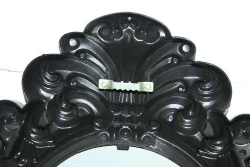 An amazing black ornately moulded oval wall mirror in great condition. RS17M