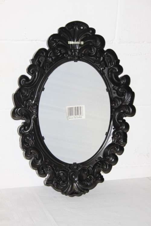 An amazing black ornately moulded oval wall mirror in great condition. RS17M