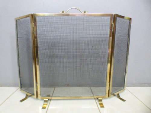 An awesome vintage Brass and metal mesh fireplace screen. Wonderful on display in front a fireplace!
