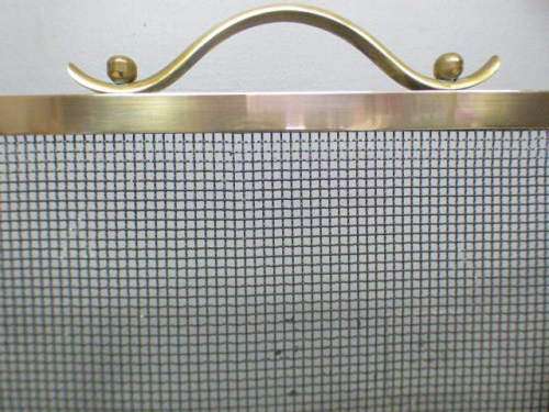An awesome vintage Brass and metal mesh fireplace screen. Wonderful on display in front a fireplace!
