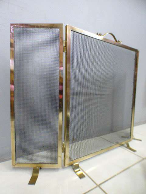 An awesome vintage Brass and metal mesh fireplace screen. Wonderful on display in front a fireplace!