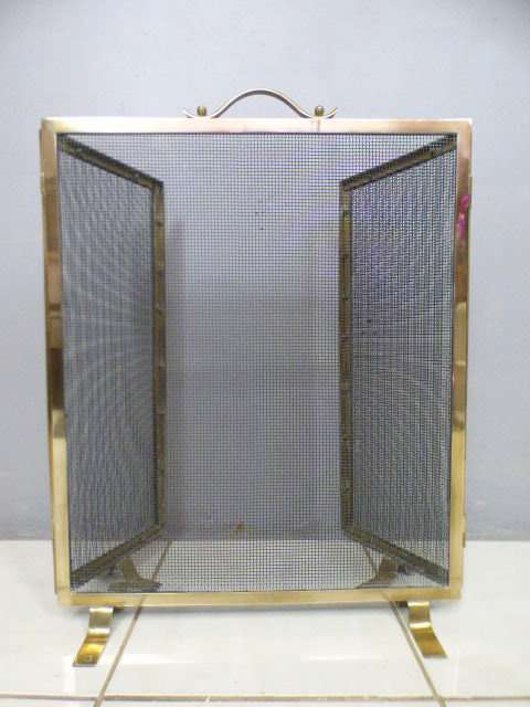 An awesome vintage Brass and metal mesh fireplace screen. Wonderful on display in front a fireplace!