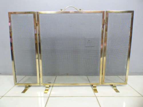 An awesome vintage Brass and metal mesh fireplace screen. Wonderful on display in front a fireplace!