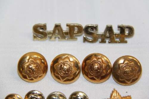 A stunning large collection of South African Police buttons and badges including "SAP" badges