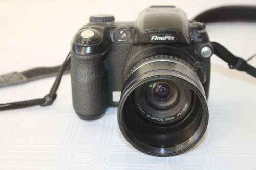 A Fujifilm FinePix S5000 Zoom with a strap in a high quality Lowepro bag