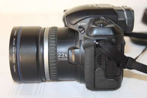A Fujifilm FinePix S5000 Zoom with a strap in a high quality Lowepro bag