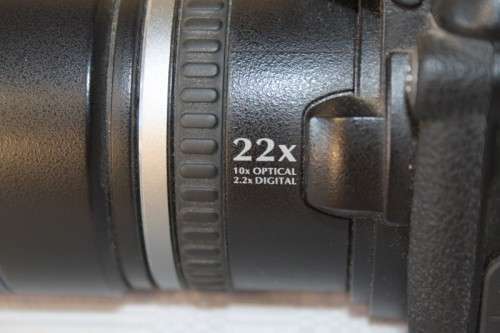 A Fujifilm FinePix S5000 Zoom with a strap in a high quality Lowepro bag