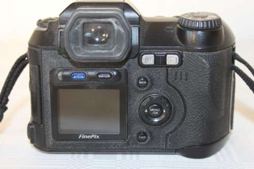 A Fujifilm FinePix S5000 Zoom with a strap in a high quality Lowepro bag