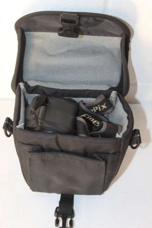 A Fujifilm FinePix S5000 Zoom with a strap in a high quality Lowepro bag