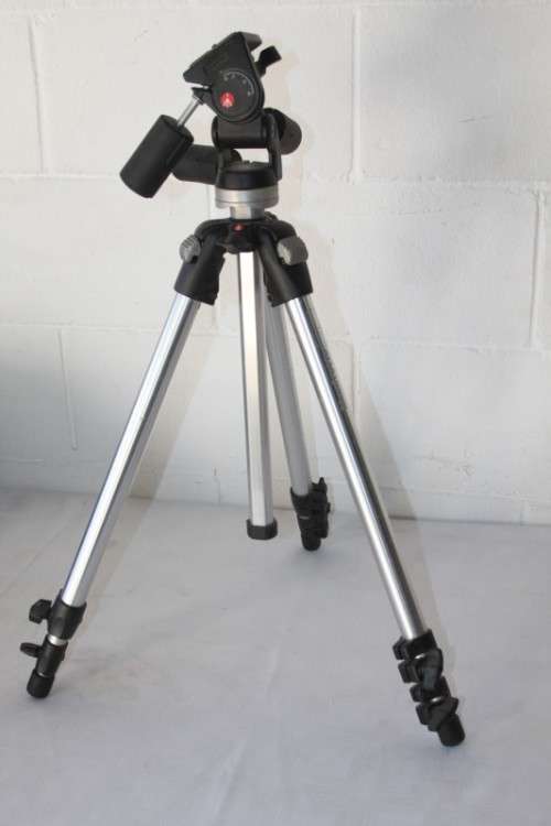 A durable and good quality Manfrotto 190D tripod with a strap in the original box