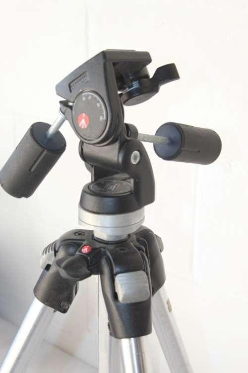 A durable and good quality Manfrotto 190D tripod with a strap in the original box