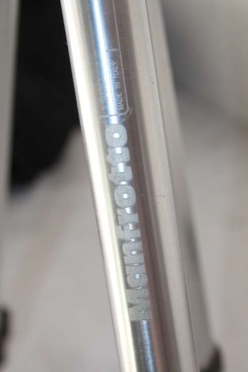A durable and good quality Manfrotto 190D tripod with a strap in the original box