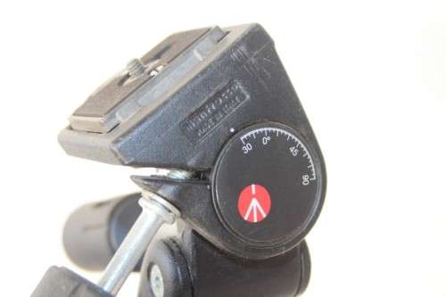 A durable and good quality Manfrotto 190D tripod with a strap in the original box