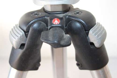 A durable and good quality Manfrotto 190D tripod with a strap in the original box
