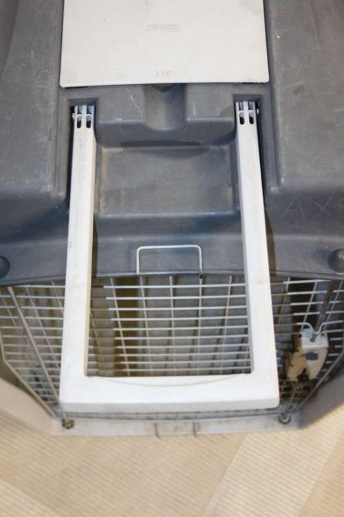 A large pet kennel/ travel case with two storage compartments on top