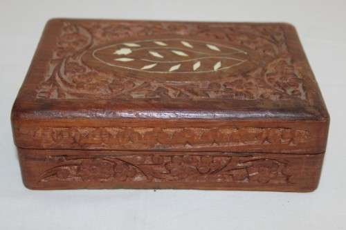 A beautiful hand carved wooden playing card/ storage box with lovely detailing on it