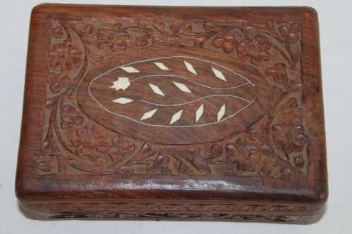 A beautiful hand carved wooden playing card/ storage box with lovely detailing on it