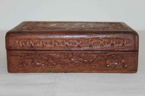 A beautiful hand carved wooden playing card/ storage box with lovely detailing on it