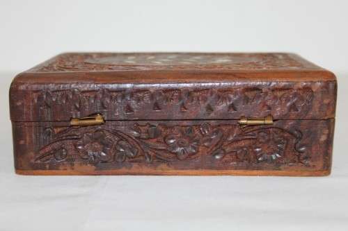 A beautiful hand carved wooden playing card/ storage box with lovely detailing on it