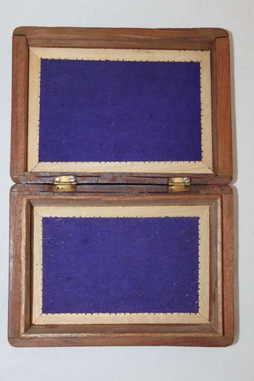 A beautiful hand carved wooden playing card/ storage box with lovely detailing on it