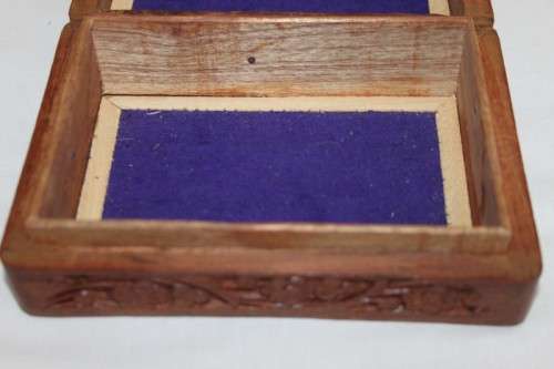 A beautiful hand carved wooden playing card/ storage box with lovely detailing on it