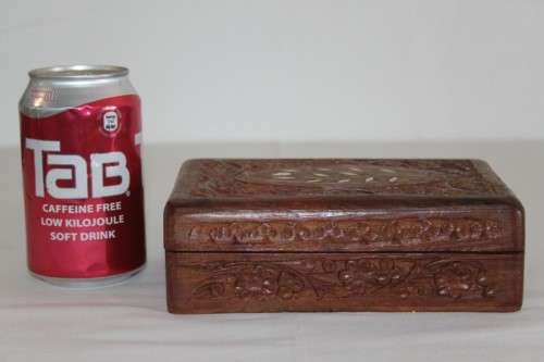 A beautiful hand carved wooden playing card/ storage box with lovely detailing on it