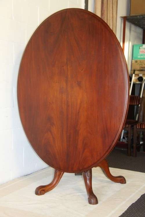 A magnificent antique carved oval Georgian Rosewood "tilt top" hall table in spectacular condition!