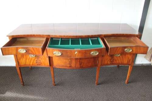 A magnificent Kingswood finished Regency buffet/ side server with spade feet and a curved front