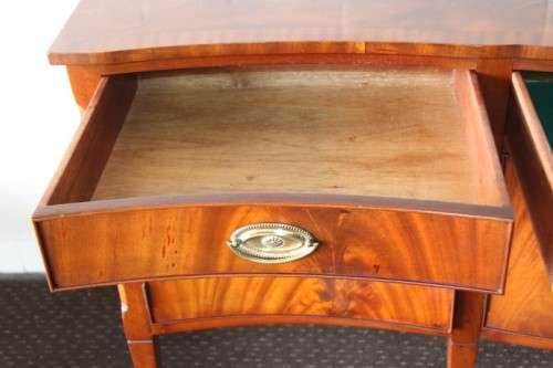 A magnificent Kingswood finished Regency buffet/ side server with spade feet and a curved front