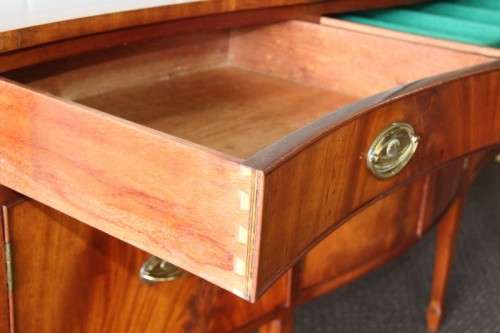 A magnificent Kingswood finished Regency buffet/ side server with spade feet and a curved front