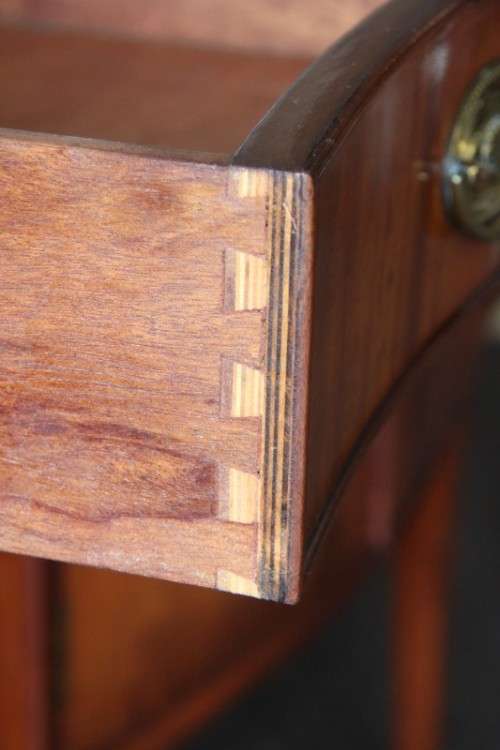 A magnificent Kingswood finished Regency buffet/ side server with spade feet and a curved front