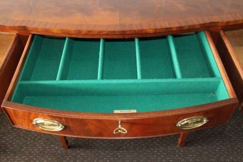 A magnificent Kingswood finished Regency buffet/ side server with spade feet and a curved front
