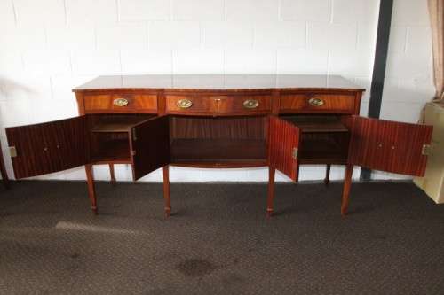 A magnificent Kingswood finished Regency buffet/ side server with spade feet and a curved front
