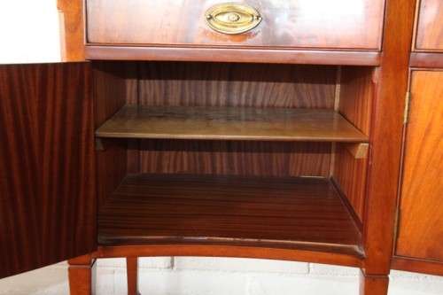 A magnificent Kingswood finished Regency buffet/ side server with spade feet and a curved front