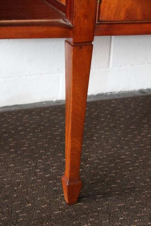 A magnificent Kingswood finished Regency buffet/ side server with spade feet and a curved front