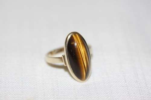 An exquisite vintage 9ct yellow gold ladies "oval" setting tigers eye ring by Birger Haglund
