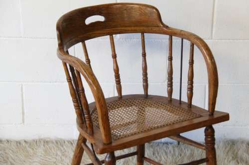 A magnificent Edwardian antique solid oak tub chair with a wicker bottom - very collectable!