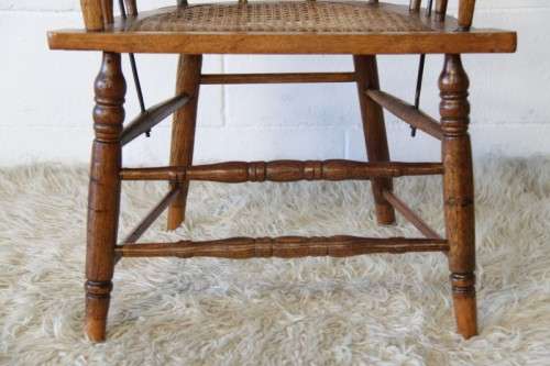A magnificent Edwardian antique solid oak tub chair with a wicker bottom - very collectable!
