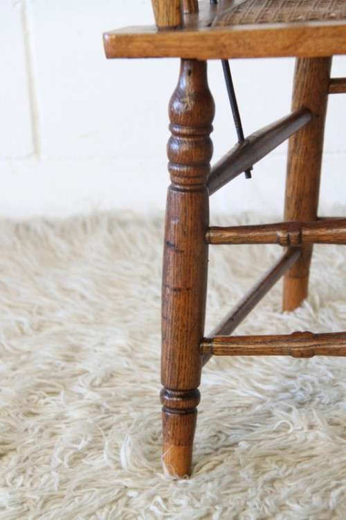 A magnificent Edwardian antique solid oak tub chair with a wicker bottom - very collectable!