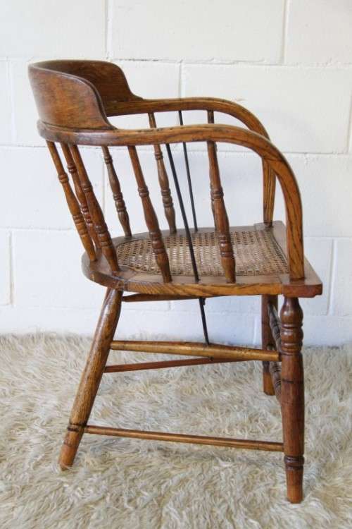 A magnificent Edwardian antique solid oak tub chair with a wicker bottom - very collectable!