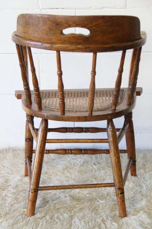 A magnificent Edwardian antique solid oak tub chair with a wicker bottom - very collectable!
