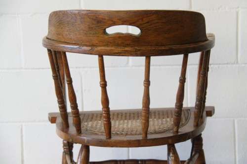 A magnificent Edwardian antique solid oak tub chair with a wicker bottom - very collectable!