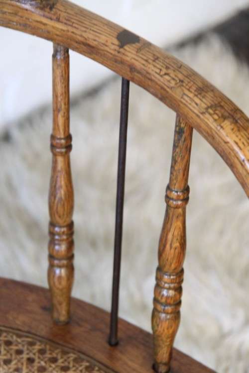 A magnificent Edwardian antique solid oak tub chair with a wicker bottom - very collectable!
